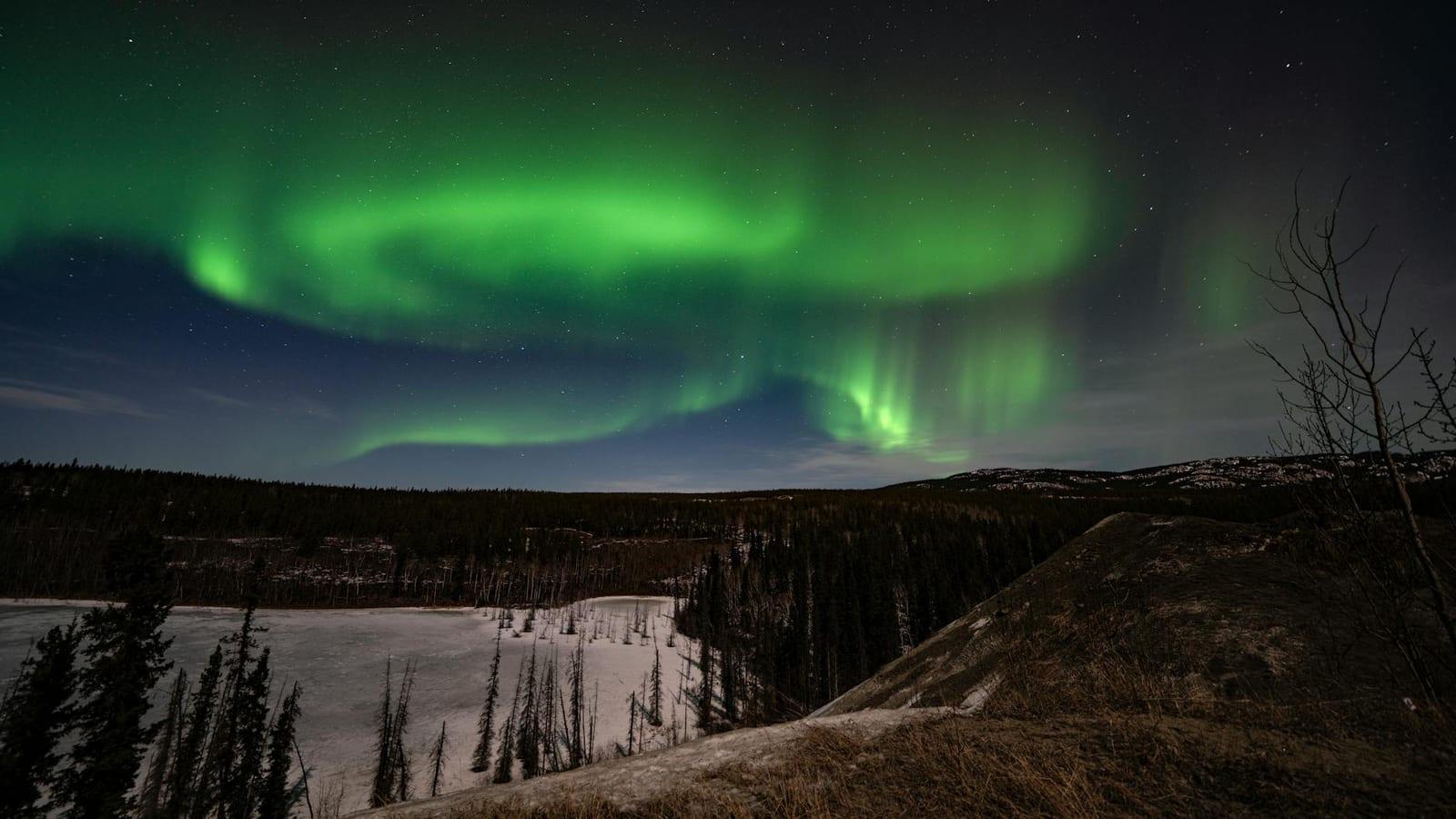 Stand under the Northern Lights in the Yukon, Canada